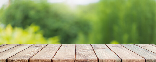 Empty wood table top and blurred green tree and vegetable in agricultural farms. background - can used for display or montage your products.