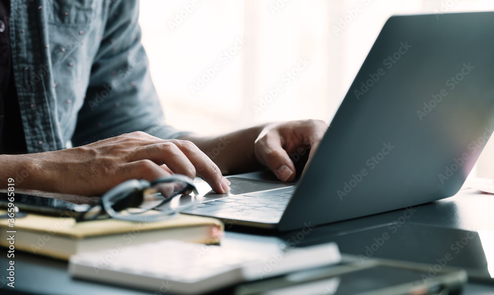 Close up businessman using laptop computer at home Close up businessman using laptop computer at home