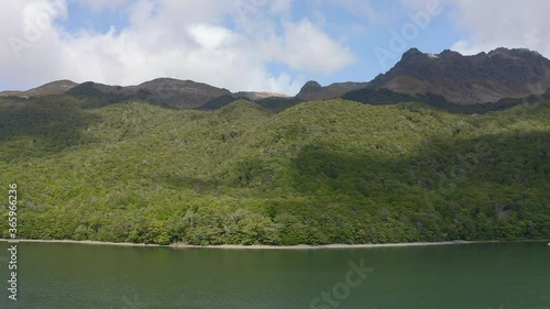 AERIAL: Tracking shot of the forests and mountains around North Mavora Lake. Mavora was used as a location in Lord of the Rings, LOTR. New Zealand, South Island. photo