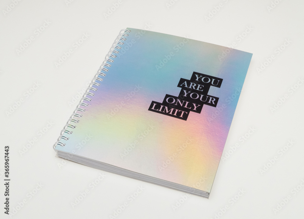 a notebook with iridiscent cover and motivational text, white background a notebook with iridiscent cover and motivational text, white background
