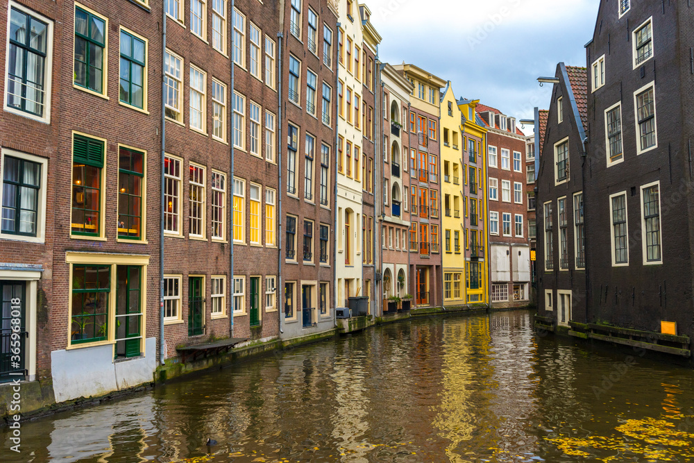 View of Colorful houses and Boats on Amsterdam Canal in Amsterdam, Netherlands 