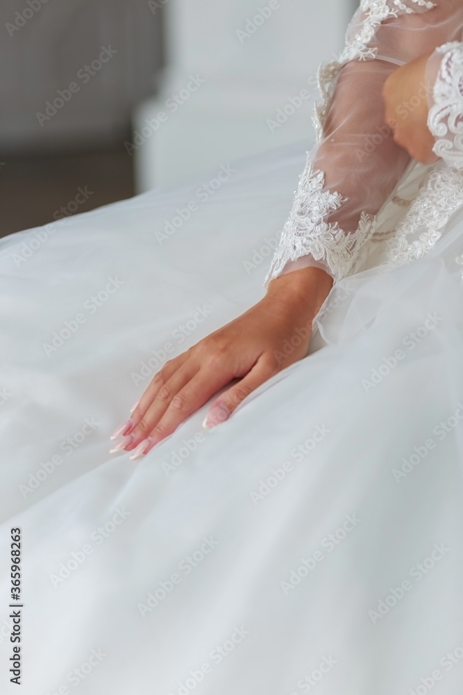 Bride's hands on a wedding dresswhite wedding dress Bride's hands on a wedding dresswhite wedding dress