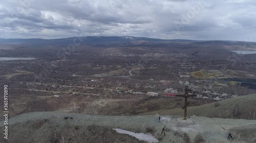 Orthodox cross on Mount Karabash and city view. the camera moves towards the city. Russia, Chelyabinsk region