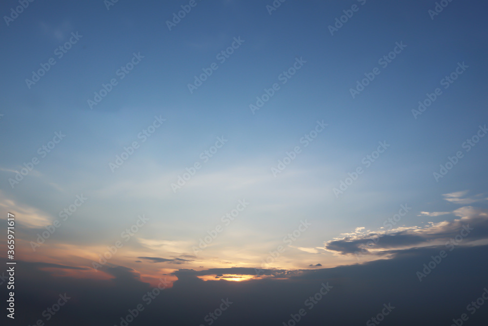 Dramatic atmosphere panorama view of beautiful twilight sky with golden sunlight and clouds on summer clear blue sky.
