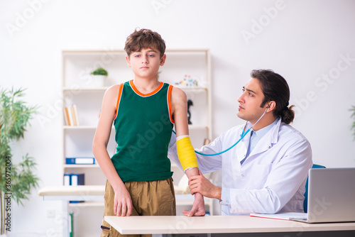 Sick boy visiting young male doctor pediatrician © Elnur