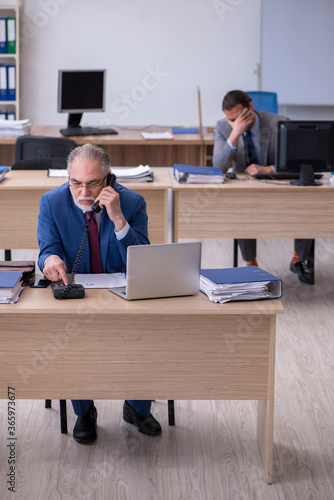 Two male employees working in the office