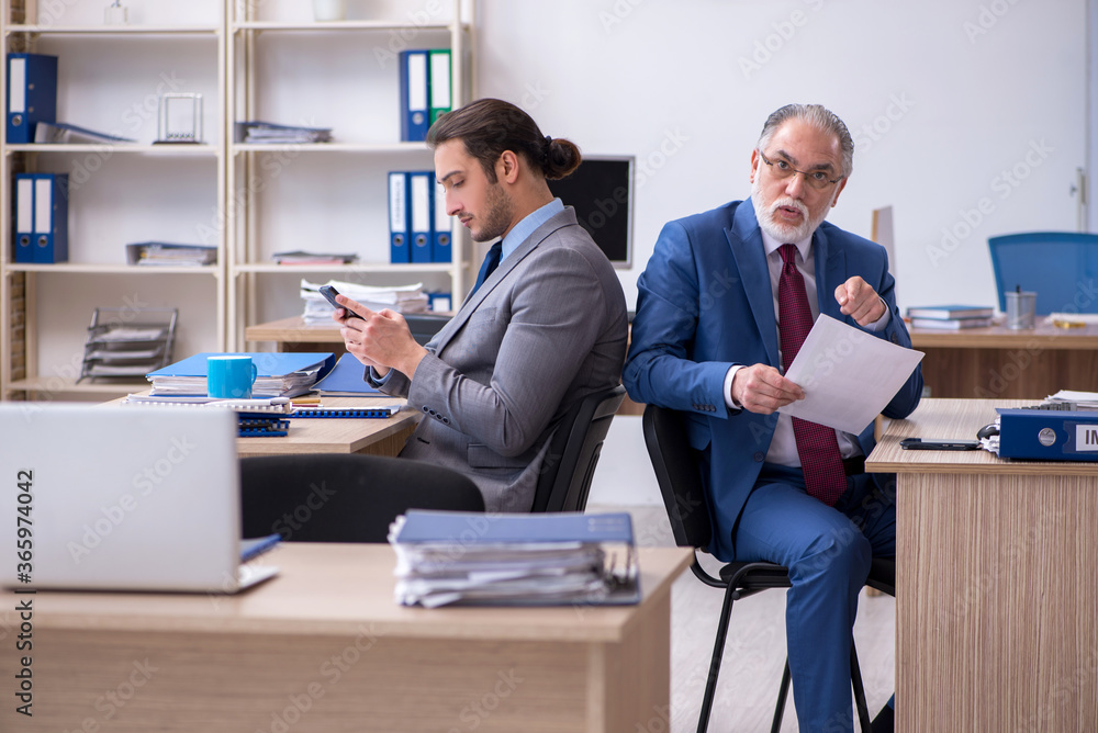 Two male employees working in the office Two male employees working in the office