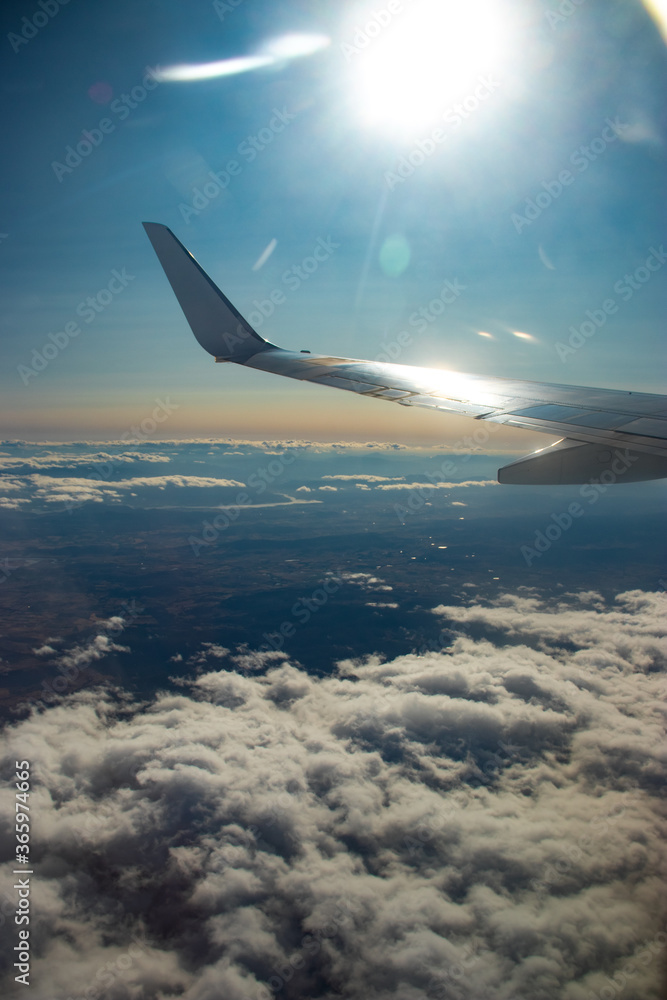 Fototapeta premium Airplane wing above the clouds