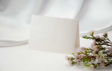 Mockup blank card, for Name place, Folded, greeting, invitation with wax flower on white background.