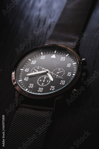 modern and elegan male watch on black