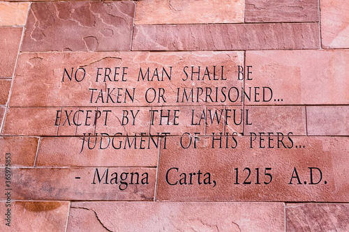 Article of Magna Carta text on of the old brick wall photo