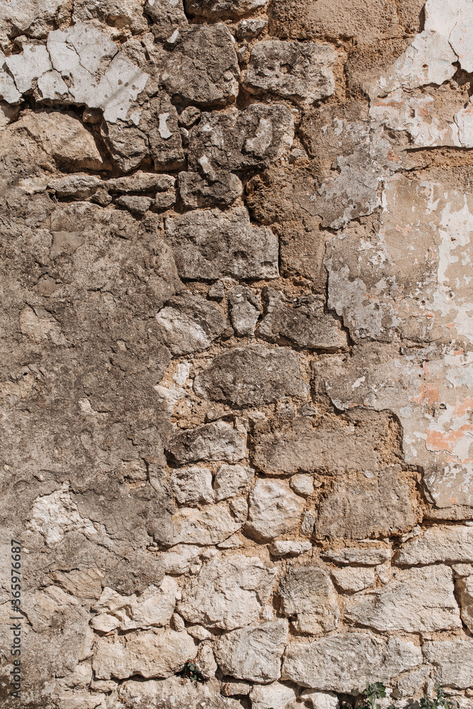 An old wall that is collapsing. Bricks visible. Textured. An old wall that is collapsing. Bricks visible. Textured.