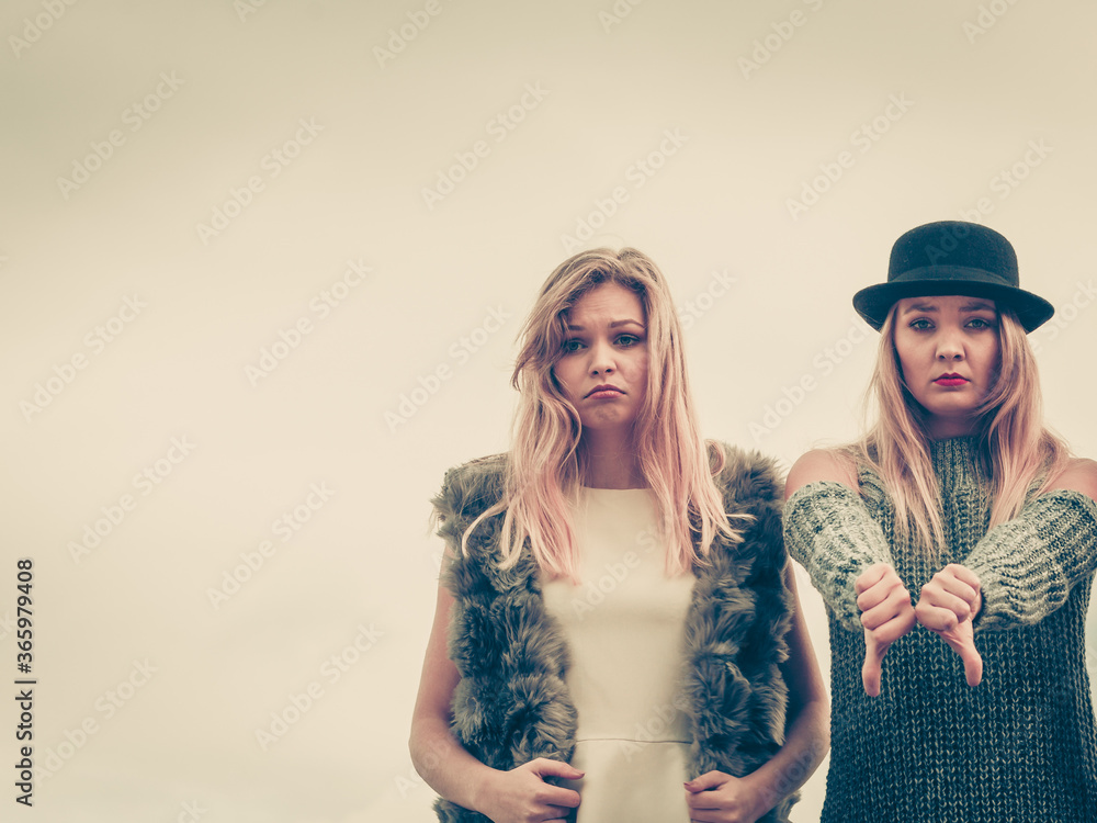 Two fashion models outdoor being sad Two fashion models outdoor being sad