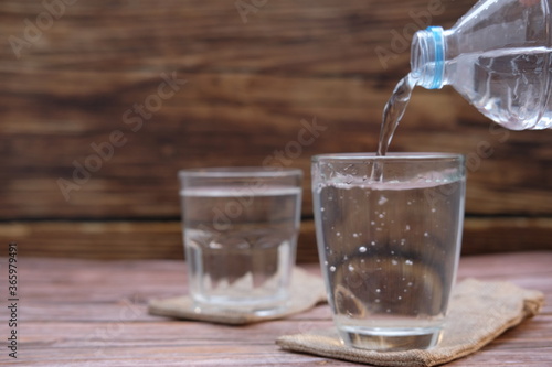 Glasses of water on a wooden table background and space for text