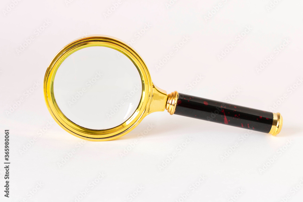 Old magnifying glass on a light background. Old magnifying glass on a light background.