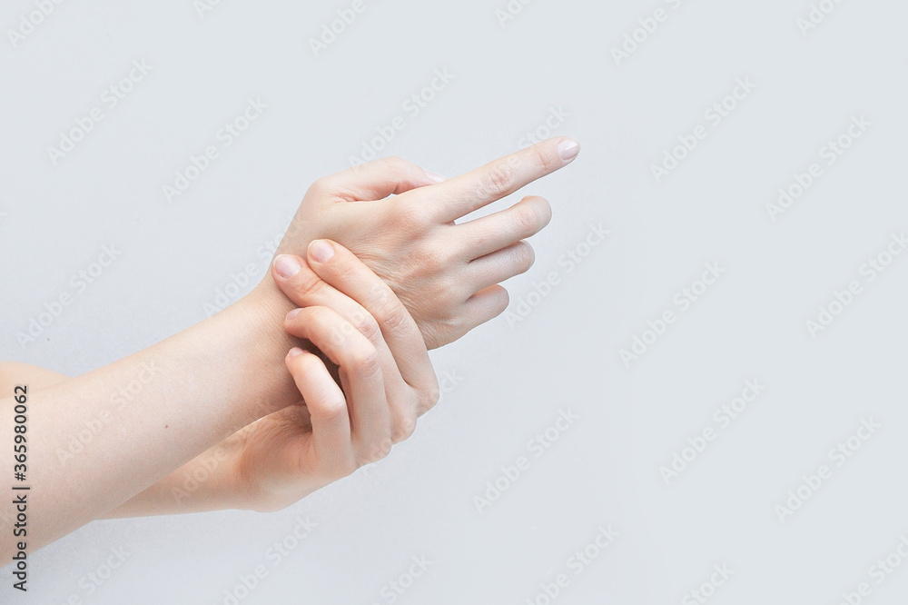 A person does self massage of the hands