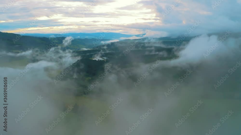 Aerial flying through mist revealing stunning rural landscape with green forest in mountains, tatra national park slovakia Aerial flying through mist revealing stunning rural landscape with green forest in mountains, tatra national park slovakia