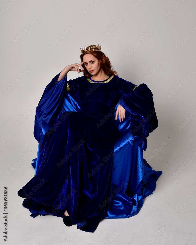 Full length portrait of girl wearing long blue velvet gown with golden ...