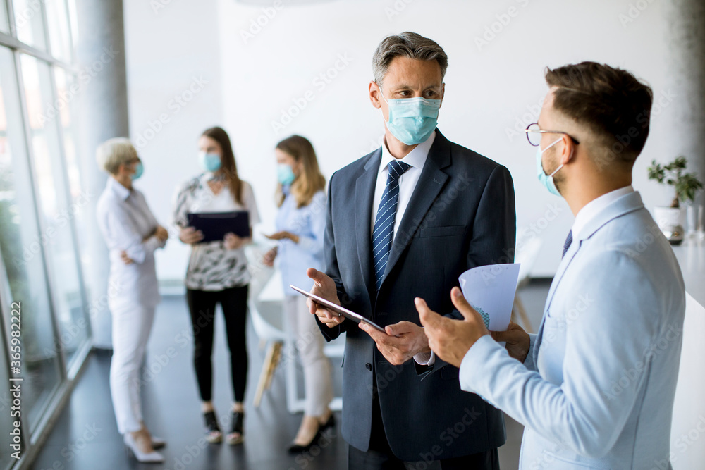 Office workers have a meeting with face masks as a protection from coronavirus Office workers have a meeting with face masks as a protection from coronavirus