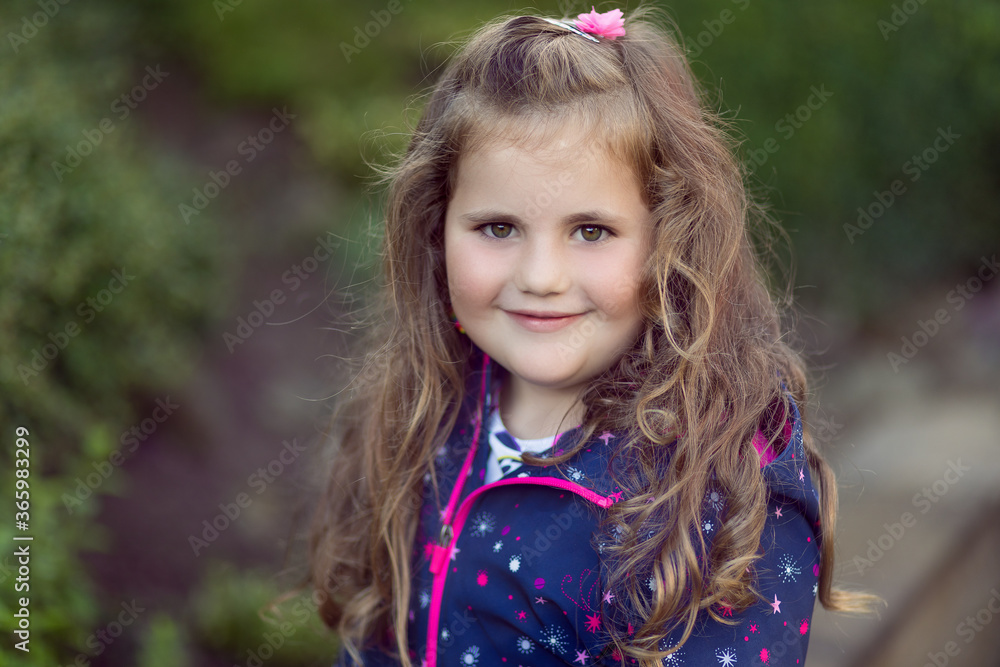 Closeup portrait of happy cute little girl with curly golden hair Closeup portrait of happy cute little girl with curly golden hair