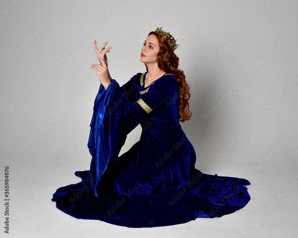 Full length portrait of girl wearing long blue velvet gown with golden ...