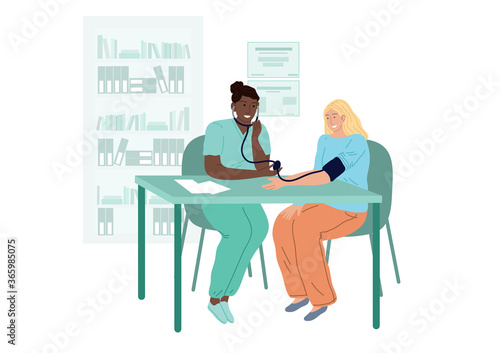 Doctor measures the patients blood pressure. A woman at a cardiologists appointment.