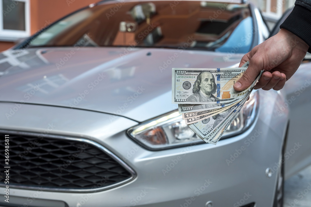 dealer make agreement to buy a new car, man holding dollar dealer make agreement to buy a new car, man holding dollar