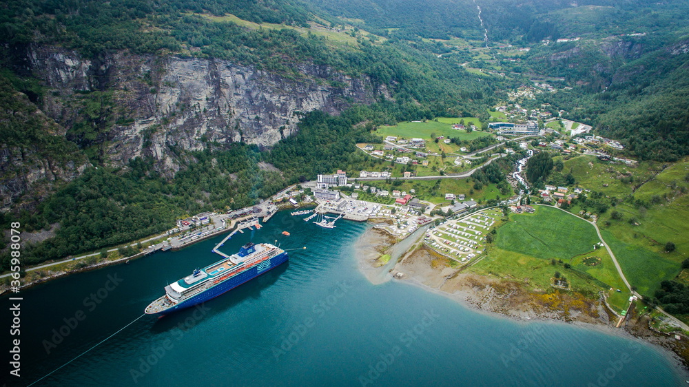 Cruise ship in Norway. Geiranger Fjord. Passenger ship in the bay between the rocks
