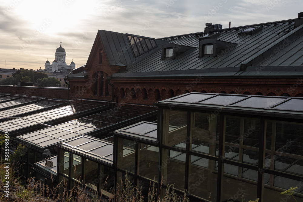 Fragments of buildings and roofs in the city of Helsinki, evening time.