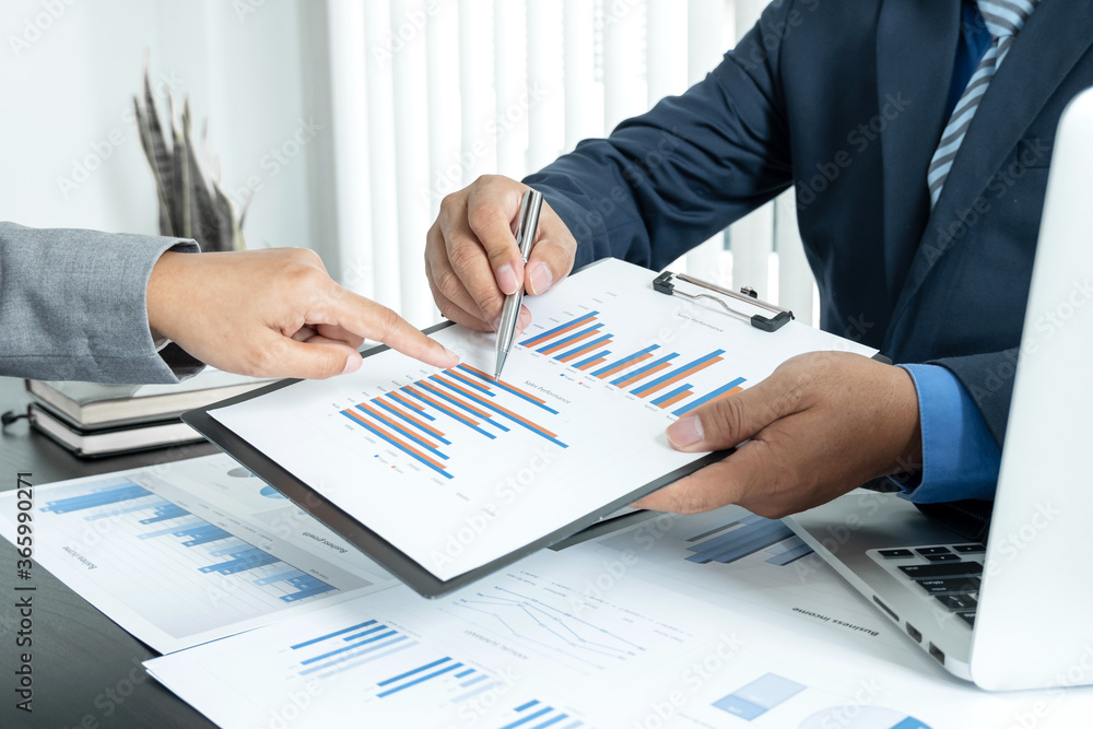 Two business leaders talk about charts, financial graphs showing results are analyzing and calculating planning strategies, business success building processes Two business leaders talk about charts, financial graphs showing results are analyzing and calculating planning strategies, business success building processes