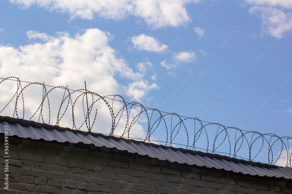 Prison wall with barbed wire. Prison wall with barbed wire.
