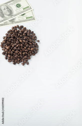 banknote put on heap of coffee beans isolated on white background