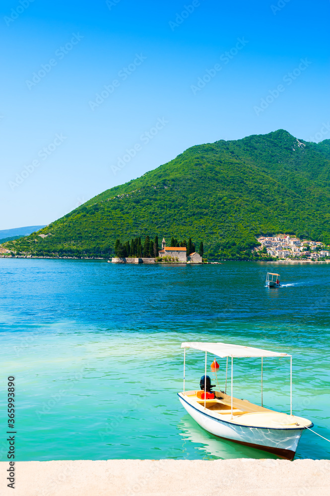 Beautiful shore in Perast town and view of St. George island in Kotor bay, Montenegro. Famous travel destination.