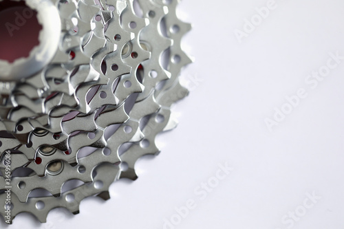 Close up of new grey toothed parts of metallic equipment isolated on white background