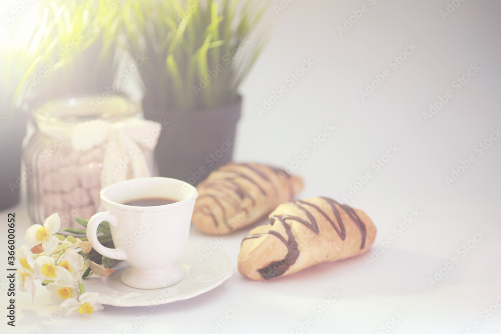 French breakfast on the table. Coffee croissant with chocolate and a decanter with cream. Fresh pastries and decaffeinated coffee. French breakfast on the table. Coffee croissant with chocolate and a decanter with cream. Fresh pastries and decaffeinated coffee.