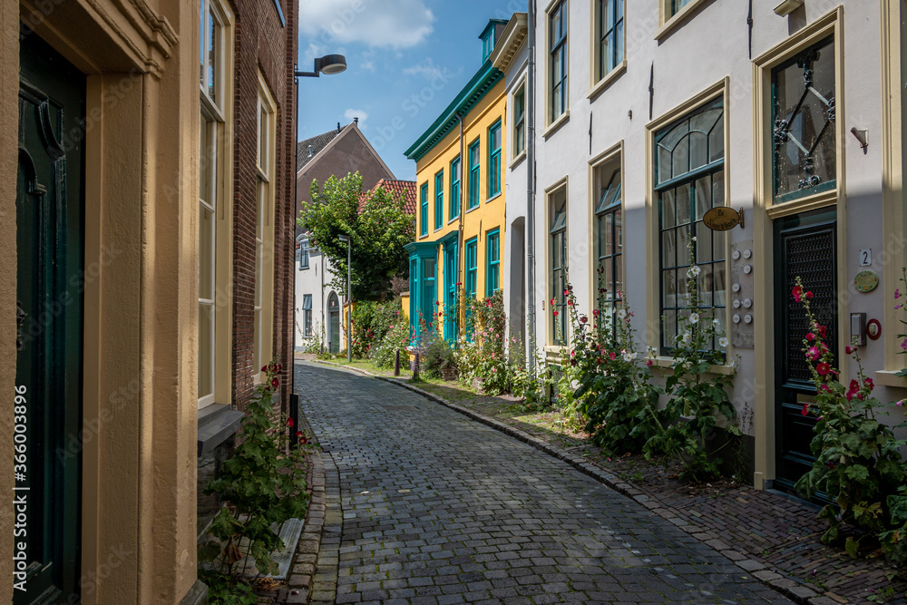 Beautiful narrow streets in the center of the Hanseatic city of Zutphen with beautiful colored houses and flowers on the side of the road