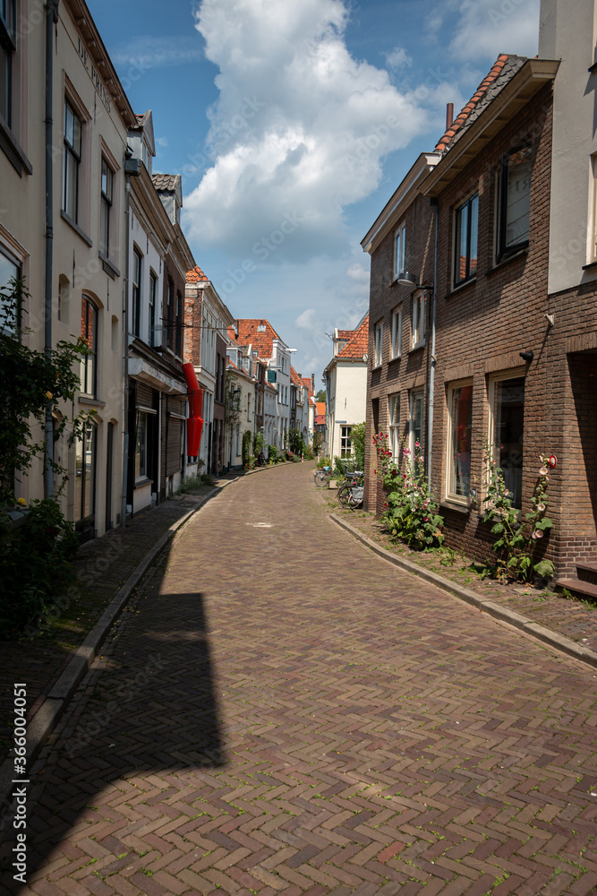 Beautiful narrow streets in the center of the Hanseatic city of Zutphen with beautiful colored houses and flowers on the side of the road