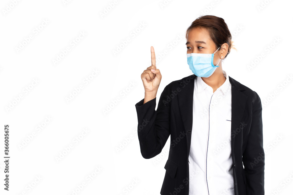 Asian businesswoman wearing surgical face mask in formal black suit jacket, pointing finger, studio lighting isolated on white background, coronavirus, COVID19 concept Asian businesswoman wearing surgical face mask in formal black suit jacket, pointing finger, studio lighting isolated on white background, coronavirus, COVID19 concept