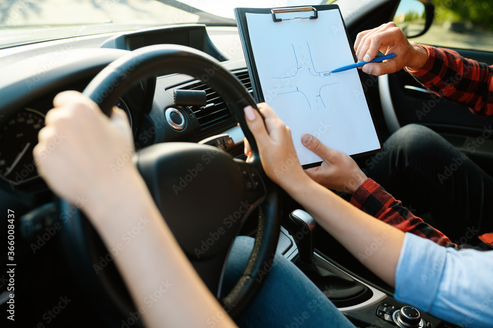 Woman and man with checklist, driving school Woman and man with checklist, driving school
