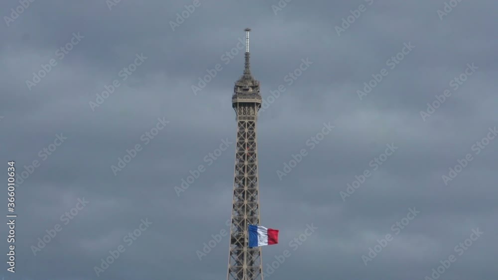 Top of the Eiffel Tower, Paris with the French flag in front. Close up. Stock Video Clip Footage Top of the Eiffel Tower, Paris with the French flag in front. Close up. Stock Video Clip Footage