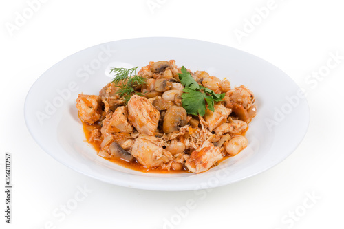 Beans with mushrooms and chicken, stewed in tomato sauce, closeup