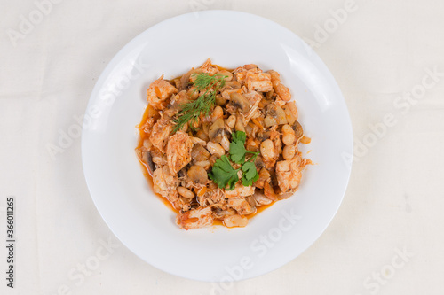 Stew beans with mushrooms, chicken in tomato sauce, top view