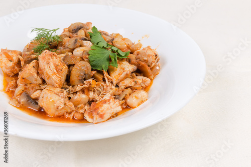 Stew beans with mushrooms, chicken in tomato sauce, close-up
