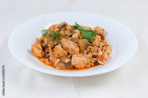 Stew beans with mushrooms, chicken in tomato sauce on dish