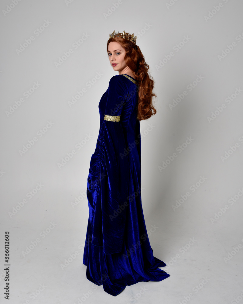 Full length portrait of girl wearing long blue velvet gown with golden ...