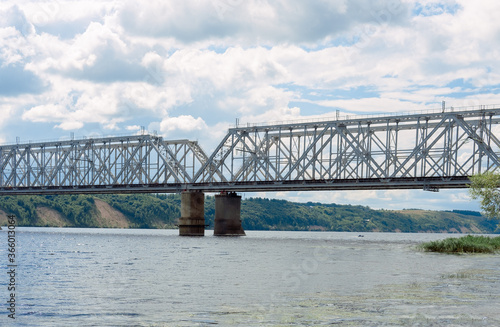 railway bridge over the river. railway crossing over the water. large iron structure on the sea