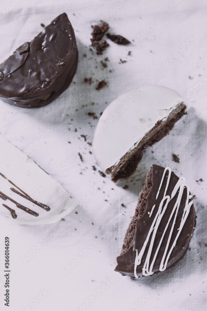 white and dark chocolate alfajores dessert on white background