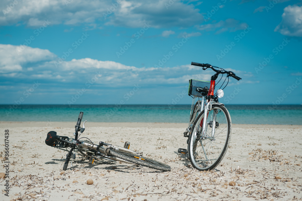 Fototapeta premium Two bicycles at the beach with blue sky