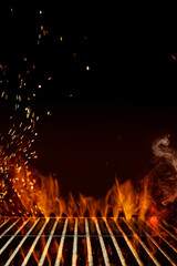 Empty steel barbecue BBQ grill grate with flaming fire, sparks and smoke on black background. Cooking concept. Close up, copy space
