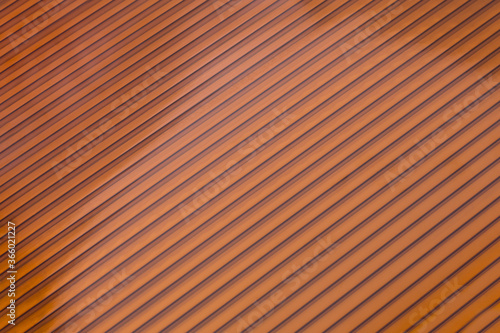Colored plastic sheet panel image. Bronze translucent roofing sheet texture, close up. Hollow Polycarbonate Sheet Roofing Panel Colored Plastic Production.
